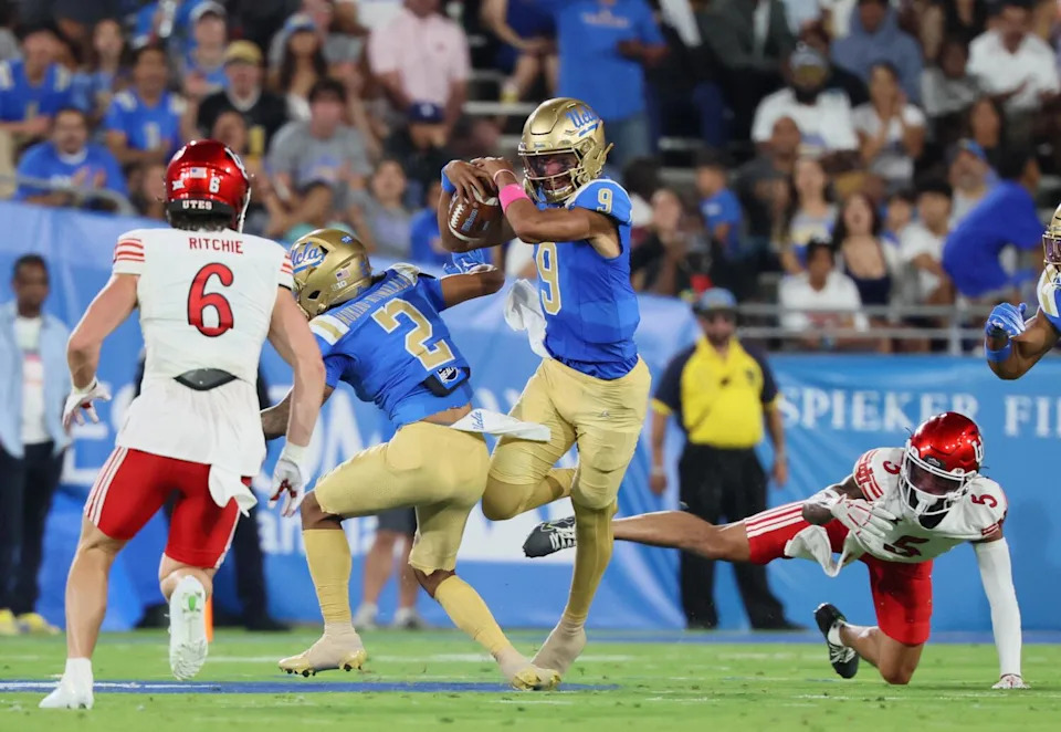 UCLA quarterback Nico Iamaleava (9) scrambles as he is tripped up by Utah safety Tao Johnson (5) Saturday at the Rose Bowl.