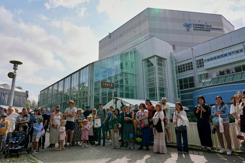 Moomins fans congregate outside the Tampere Hall, which houses the Moomins Museum, to celebrate the anniversary. Photo: AP
