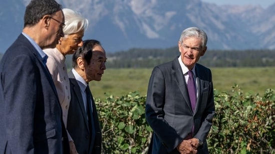 Jerome Powell walks with fellow central-bank chiefs at the Fed’s annual gathering in Jackson Hole, Wyo.