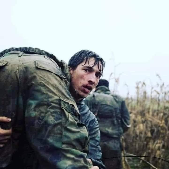 Albanian Besim Vokshi carrying a Croatian comrade during Yugoslav War against Serbs 16.11.1991  (720x722)