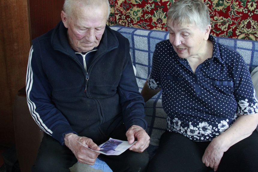Halyna and Vasyl Khyliuk look at a picture of their son Dmytro in their home in Kozarovychi, Ukraine.