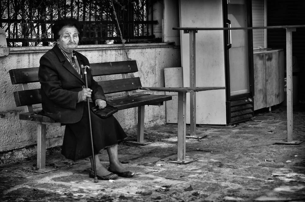 Grandma in Greece sitting alone.