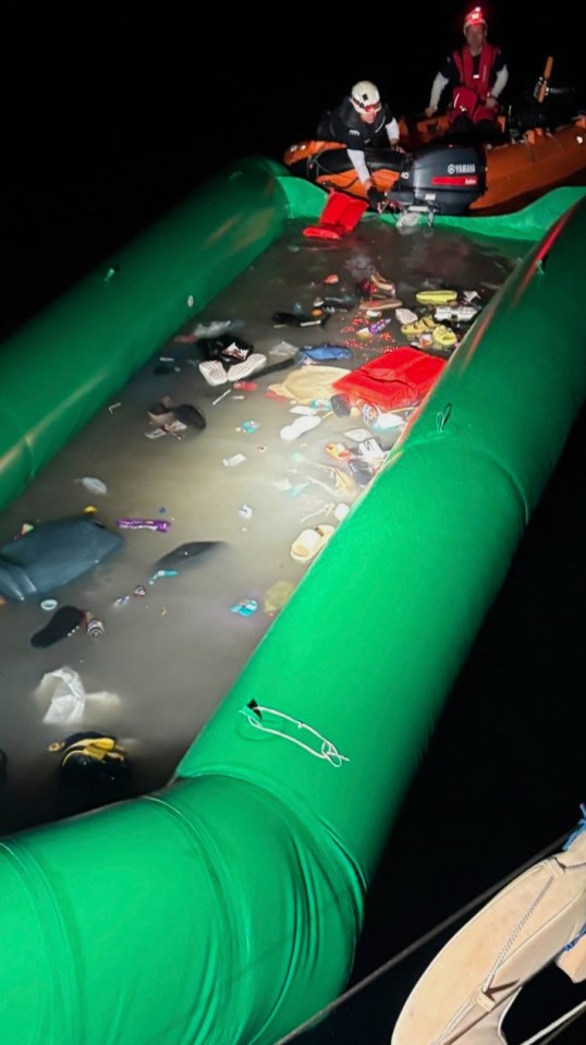 Partially flooded dinghy filled with debris following a rescue operation.