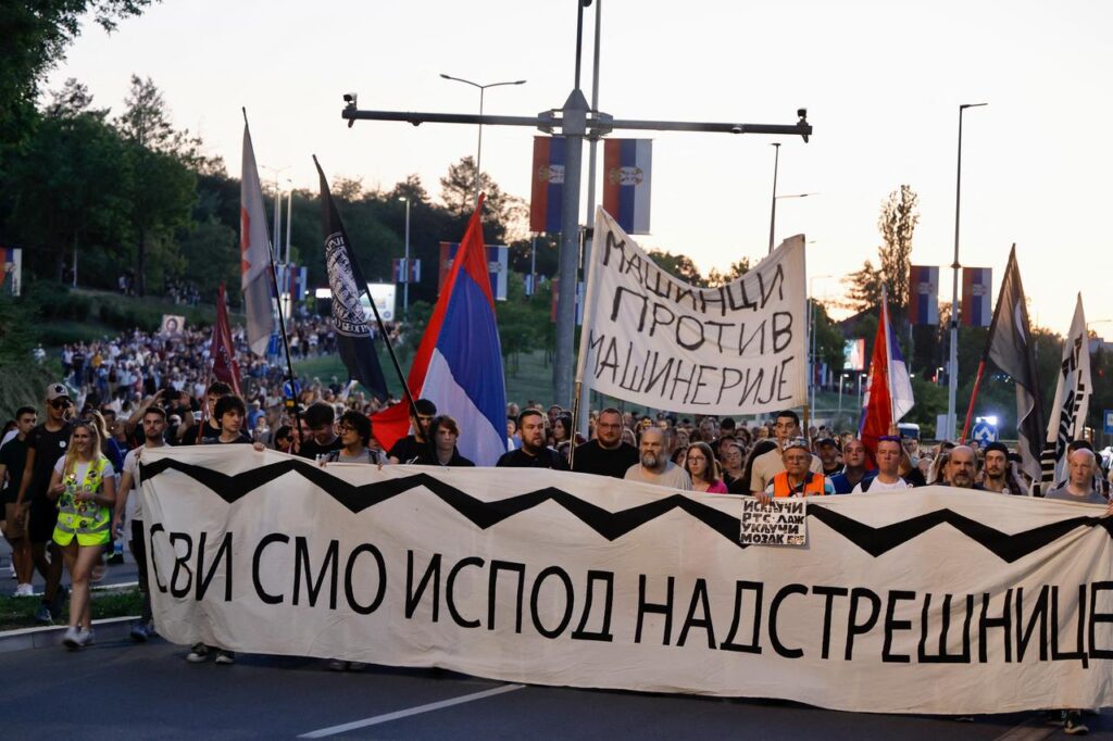 Serbia arrests ex-minister, 10 others in Novi Sad train station collapse probe Protesters gather holding a banner which reads as We are all under the canopy during the demonstration organised for the nine-month anniversary of the fatal accident at Novi Sad train station, Belgrade, Serbia on August 1, 2025. (AFP Photo)