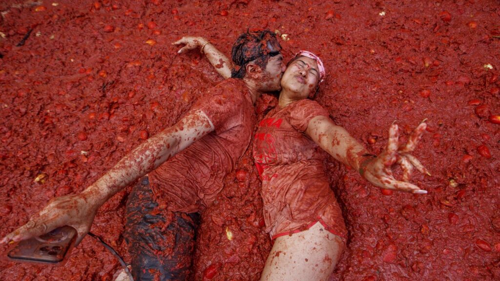Photos show revelers taking part in Tomatina, the tomato-throwing festival in Spain