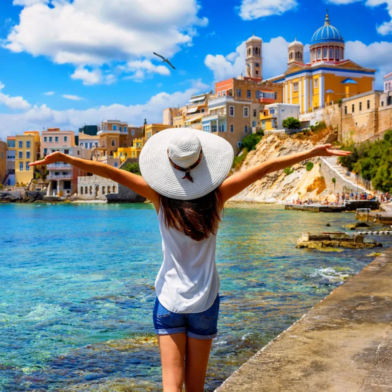 woman looks at the famous Vaporia district at Ermoupoli, Syros island, Cyclades, Greece