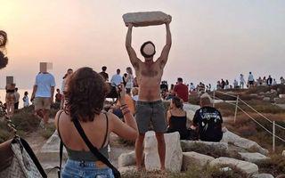 Tourist lifts ancient marble on Naxos Greece