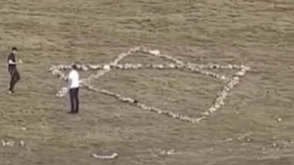 Moment Jewish holidaymakers dismantle hillside Christian cross and use stones to create giant Star of David instead