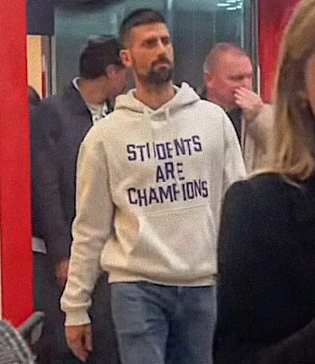 Novak Djokovic wearing a "Students Are Champions" sweatshirt.
