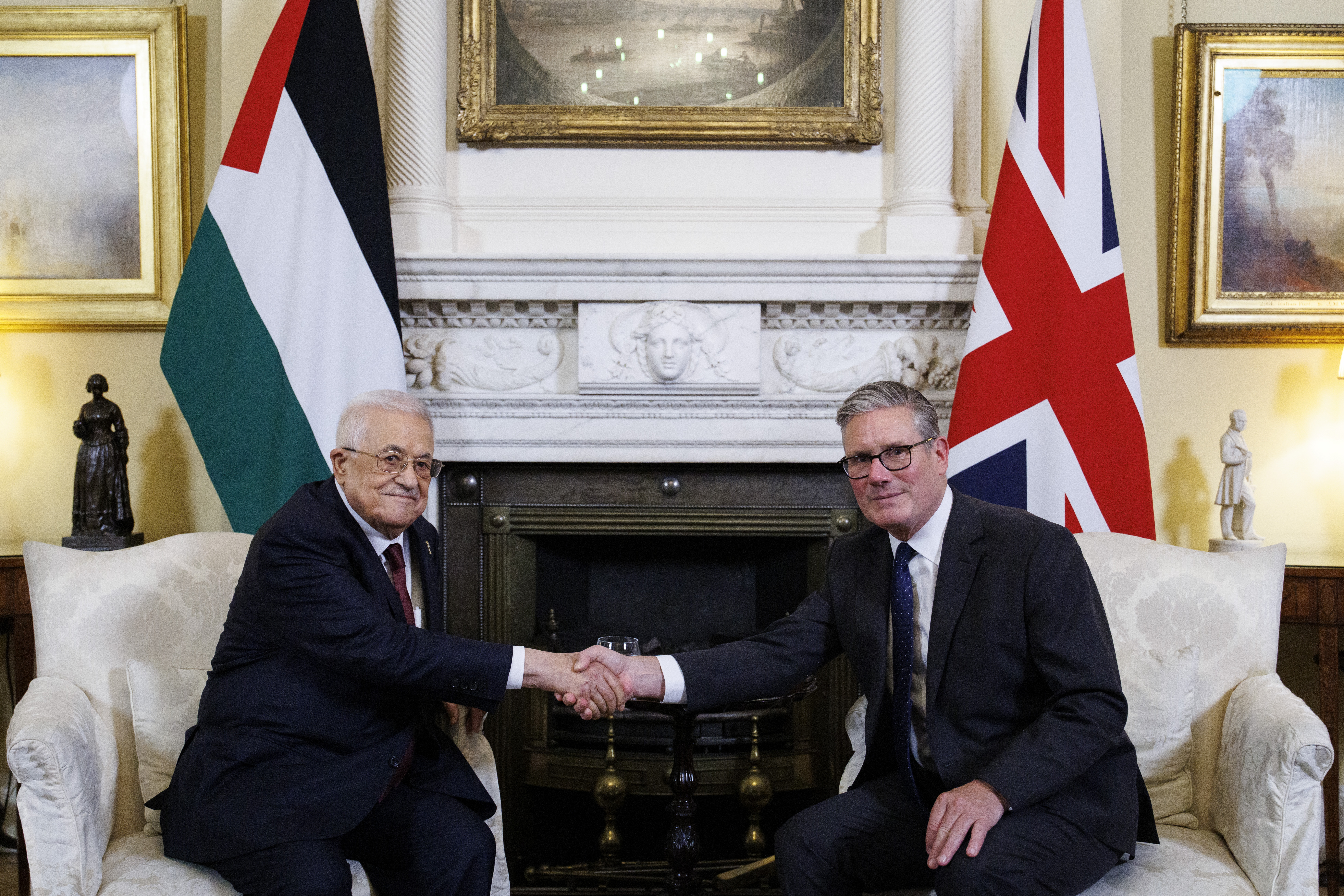 British Prime Minister Keir Starmer and Palestinian Authority President Mahmoud Abbas shaking hands at a meeting.