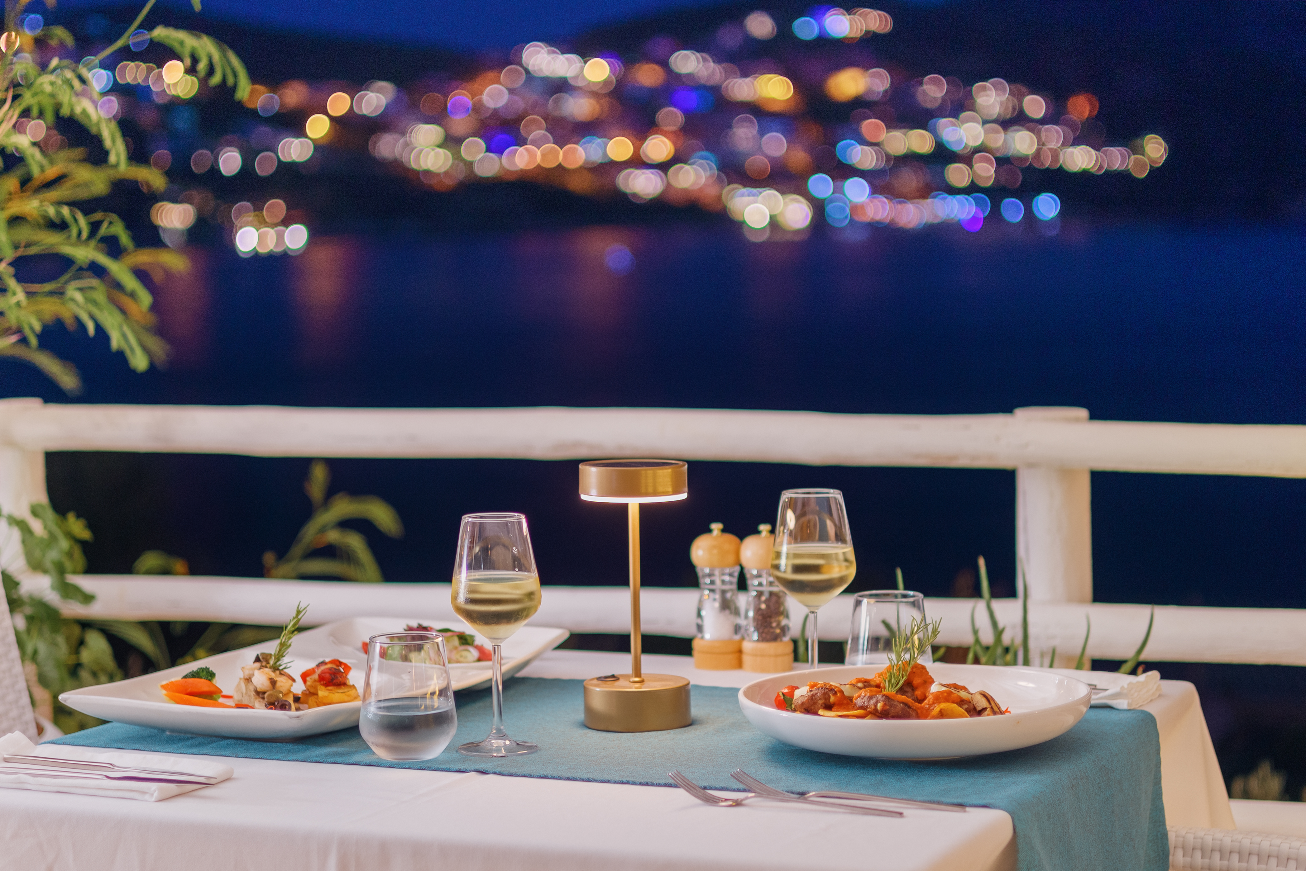 An outdoor table set for two in the evening at Likya Pavilion in Kalkan, Turkey