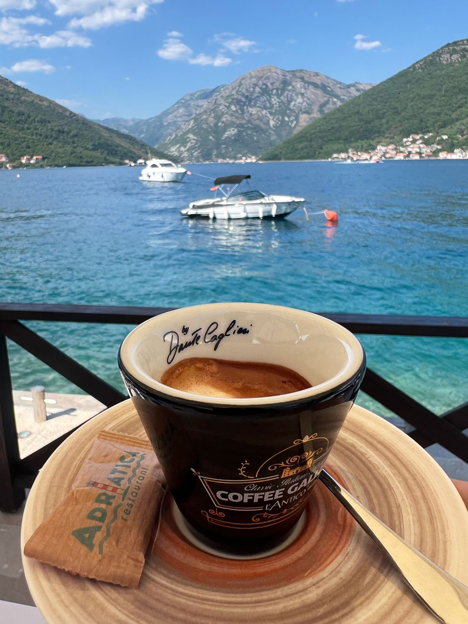 A cup of espresso with a view of the Adriatica sea in the background