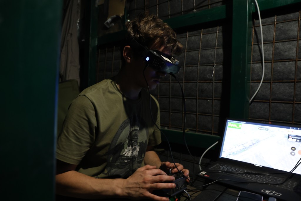 Photo: Bohdan, a drone pilot from the Unmanned Systems Battalion of Ukraine’s 110th Separate Mechanized Brigade, pilots an FPV drone in Donetsk Oblast during active battle operations. Credit: Courtesy of David Kirichenko