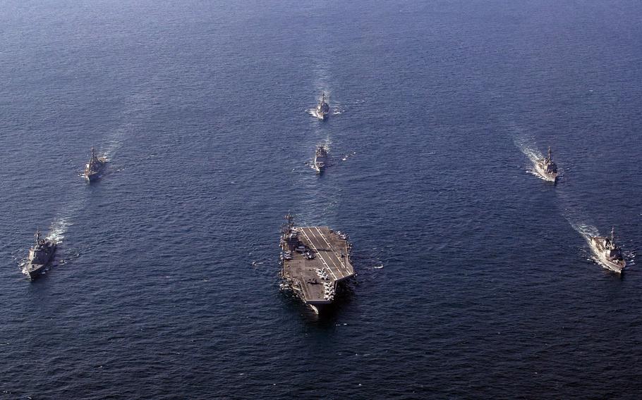 The USS George Washington sails in formation with U.S., South Korean and Japanese guided-missile destroyers.
