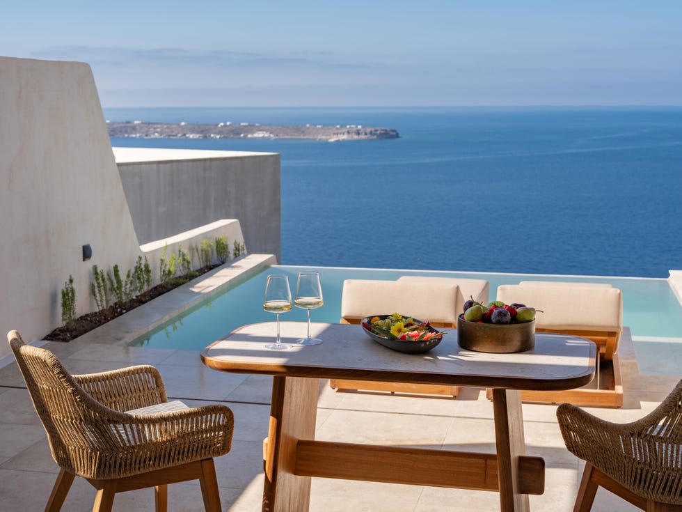 A serene outdoor dining area with a view of the ocean.