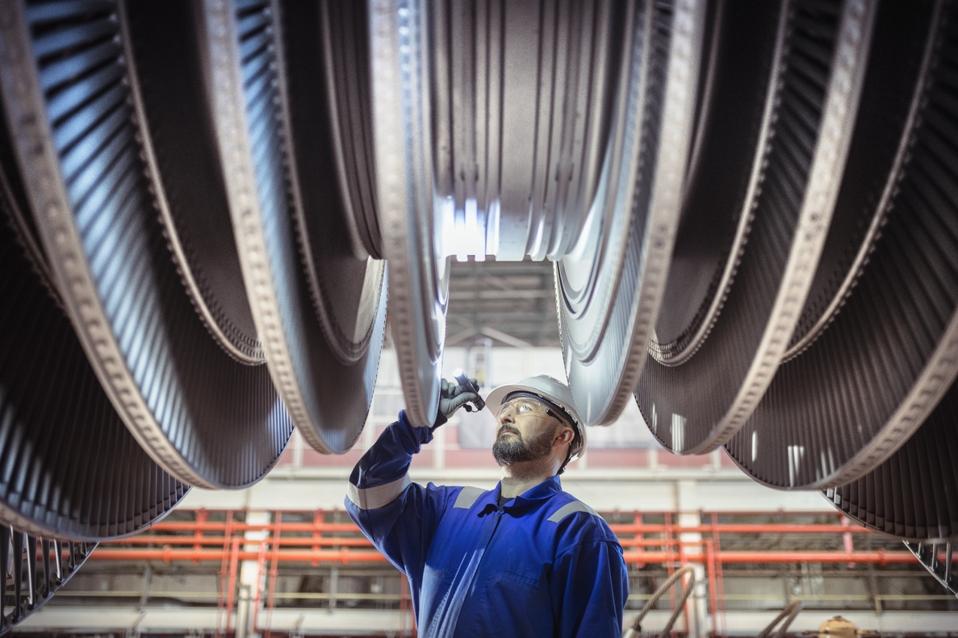 Engineer inspecting a turbine in a nuclear power station.