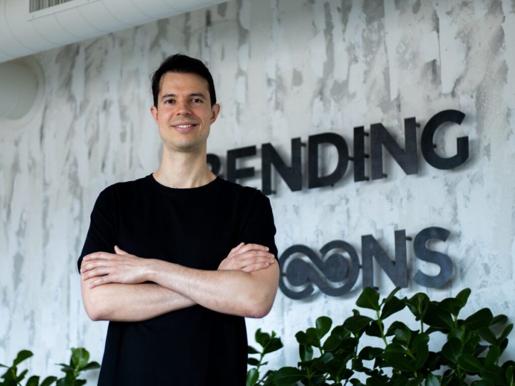 Italy’s Bending Spoons snaps up video platform Vimeo for $1.38bn Caucasian man in black tee, Bending Spoons logo behind on wall