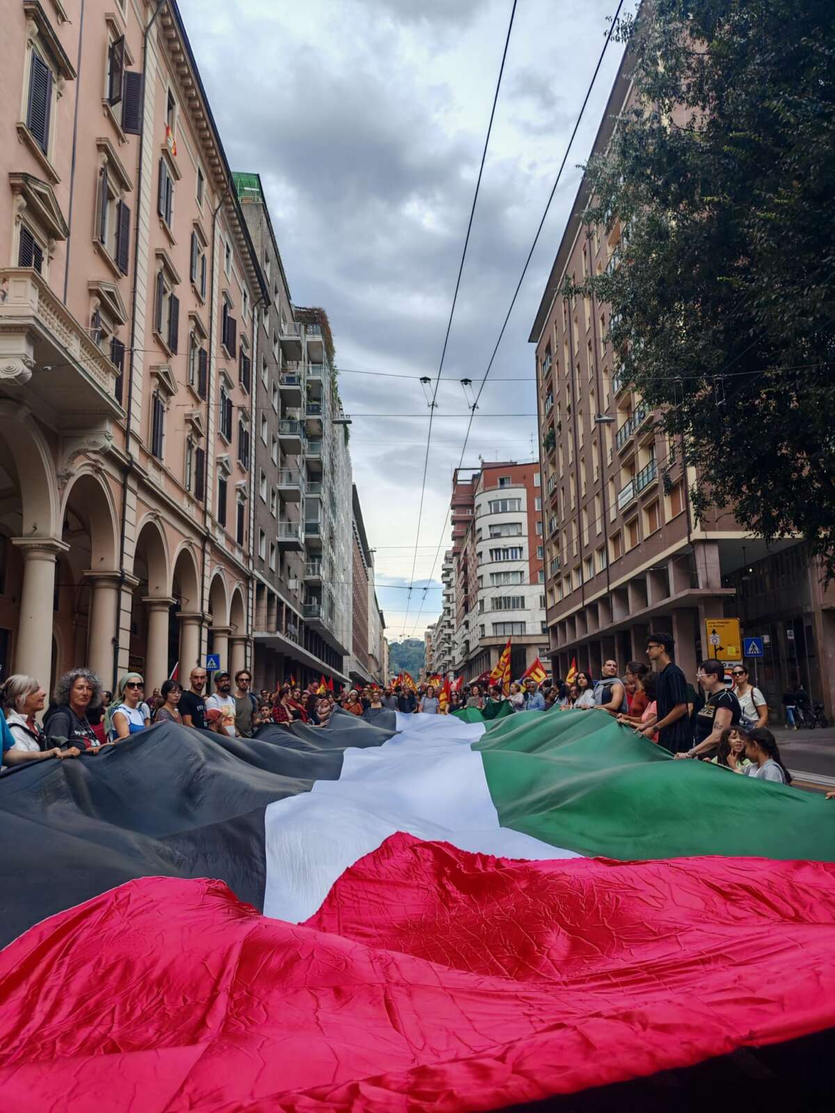 Protesters hold a Palestinian flag during a demonstration in Bologna on September 22, 2025.