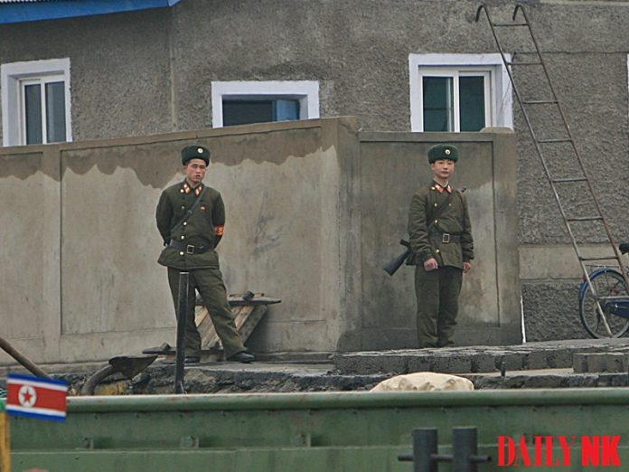 Two soldiers in North Korea in a photo taken from across the border in China.