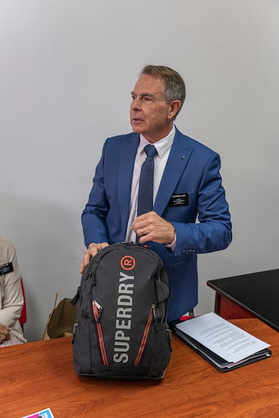 Elder Charles Lamb, a senior humanitarian missionary in Sarajevo, Bosnia-Herzegovina, shows a completed 72-hour kit at a meeting with Red Cross representatives in August 2025.