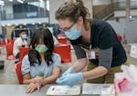Shelly Leung, 11, left, watches as Sarah Roy, RN, prepares vaccinations in Northeast Portland, Feb. 8, 2023. "Think Out Loud" hosted Oregon's health officer and epidemiologist Dr. Dean Sidelinger to talk about the newly formed Western Health Alliance, the partnership's vaccine recommendations and ongoing conversations about vaccines and public health. 