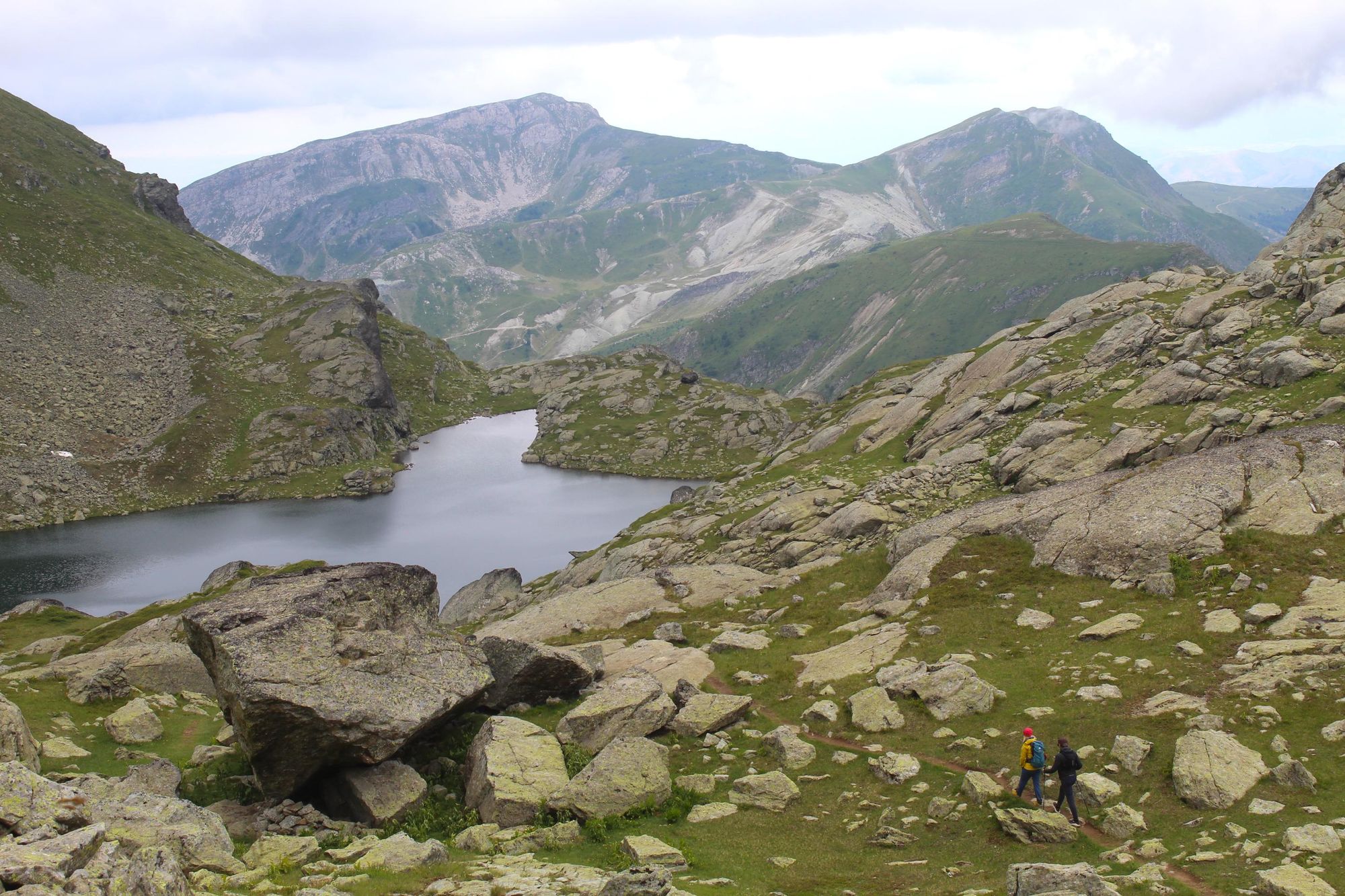 Uta guiding in the mountains of Kosovo, walking past Gjeravica Lake, beneath Gjeravica Peak. Photo: Stuart Kenny