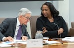 FILE - Federal Reserve Board of Governors member Lisa Cook, right, talks with Federal Reserve Chairman Jerome Powell before an open meeting of the Board of Governors at the Federal Reserve, June 25, 2025, in Washington. (AP Photo/Mark Schiefelbein, File)