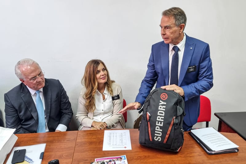 Elder Charles Lamb, right, and Sister Beth Lamb, senior humanitarian missionaries in Sarajevo, Bosnia-Herzegovina, shows a completed 72-hour kit at a meeting with Red Cross representatives in August 2025.