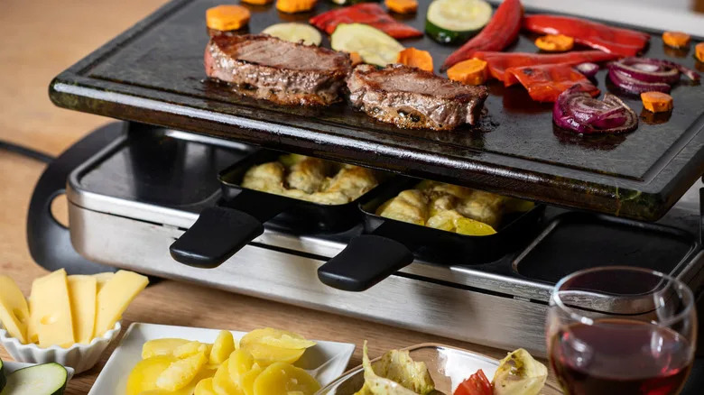 Swiss cuisine, including raclette with meat and vegetables