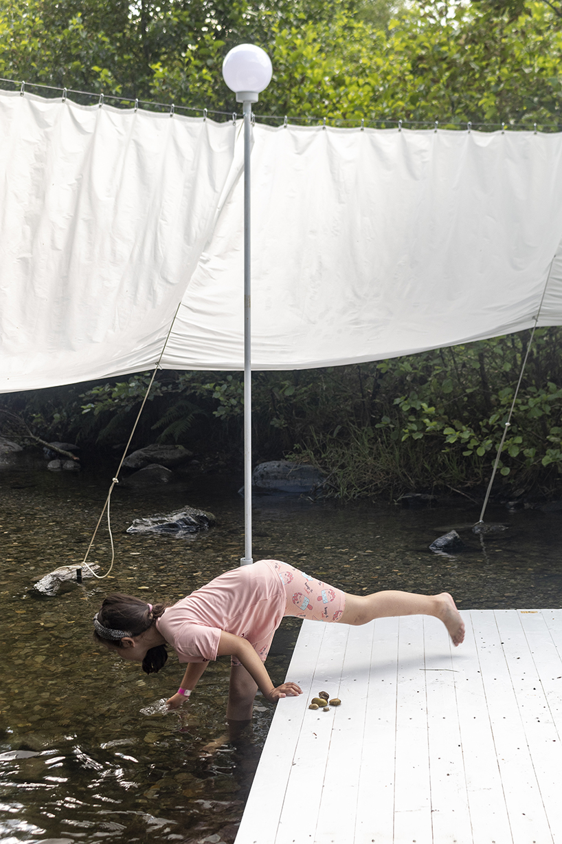 ephemeral circle textile installation by atelier VRAC activates mountain river in romania