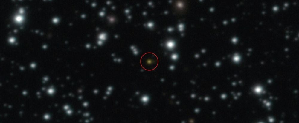 GRB 250702B is the orange dot inside the red circle in this image from the ESO’s Very Large Telescope. While most GRBs have a single flash of gamma-rays that lasts minutes or only milliseconds, this one emitted three separate flashes over the course of one day. Image Credit: ESO/A. Levan, A. Martin-Carrillo et al.