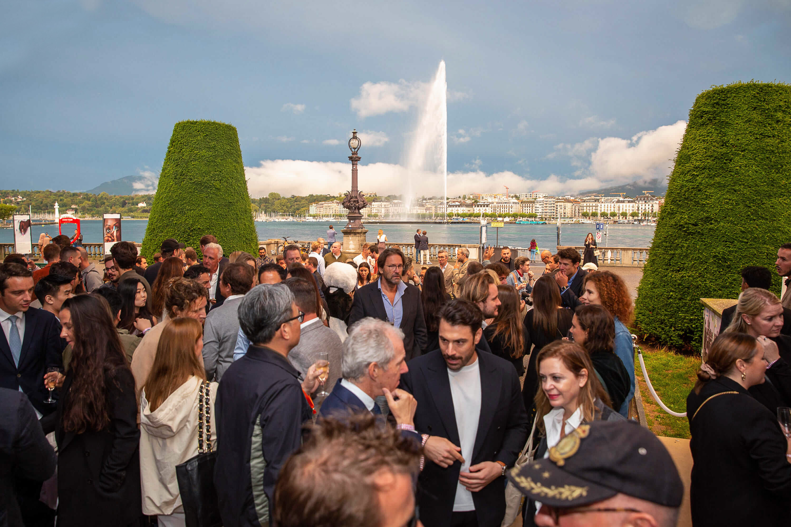people gathered in front of a lake