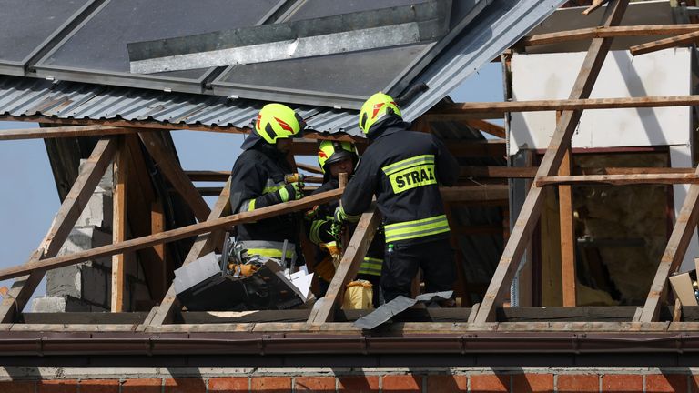 Firefighters work on the destroyed roof of a house after the Russian drone incursion into Poland. Pic: Reuters