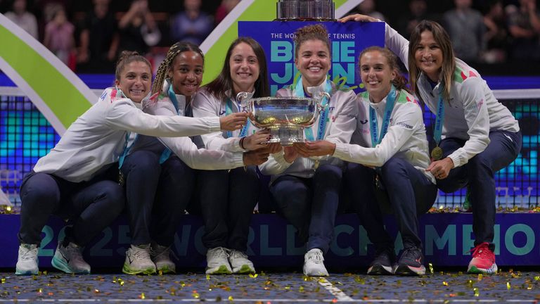 Italy's tennis team pose with the trophy on podium after winning the Billie Jean King Cup final against the United States, at the Shenzhen B