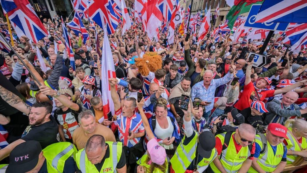 LIVE: Police 'attacked with projectiles' by Tommy Robinson supporters as 110,000 march through London | LBC