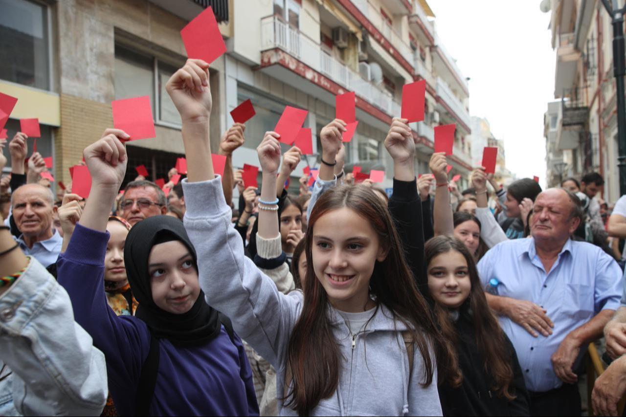 Turks from Western Thrace hold red cards and banners in Xanthi, Greece, September 25, 2023. (AA Photo)