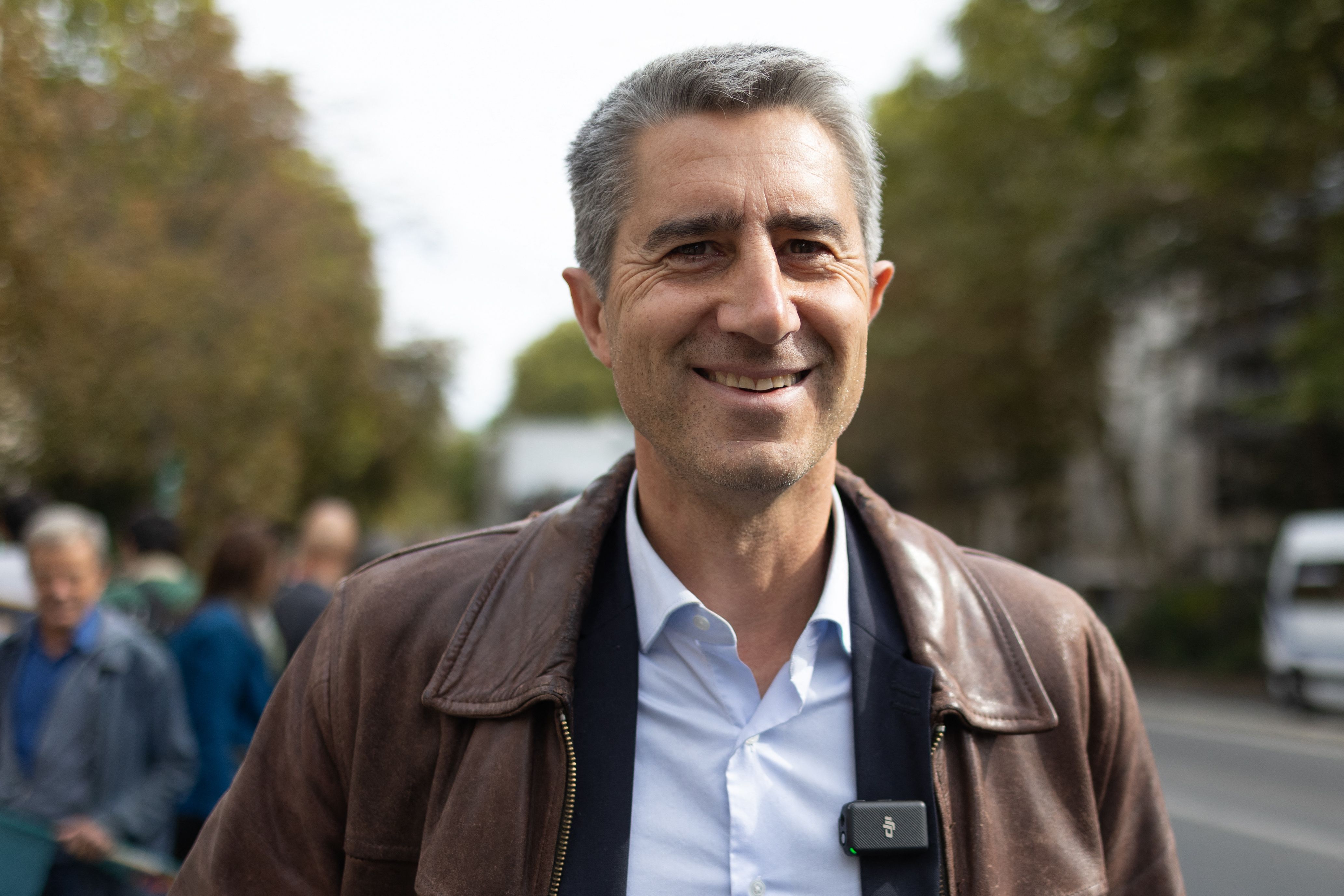 Francois Ruffin smiling during a demonstration in Paris for social justice measures.
