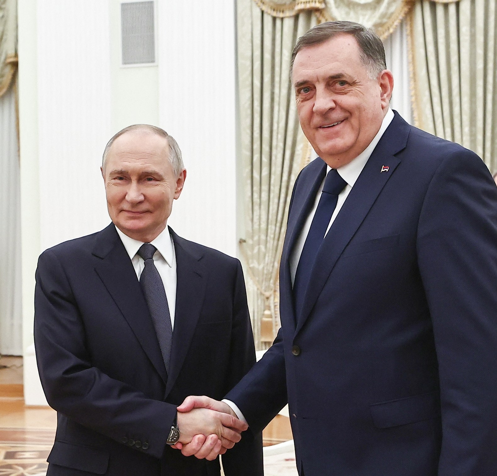 Russia's President Vladimir Putin shakes hands with Bosnian Serb leader Milorad Dodik at the Kremlin in Moscow.