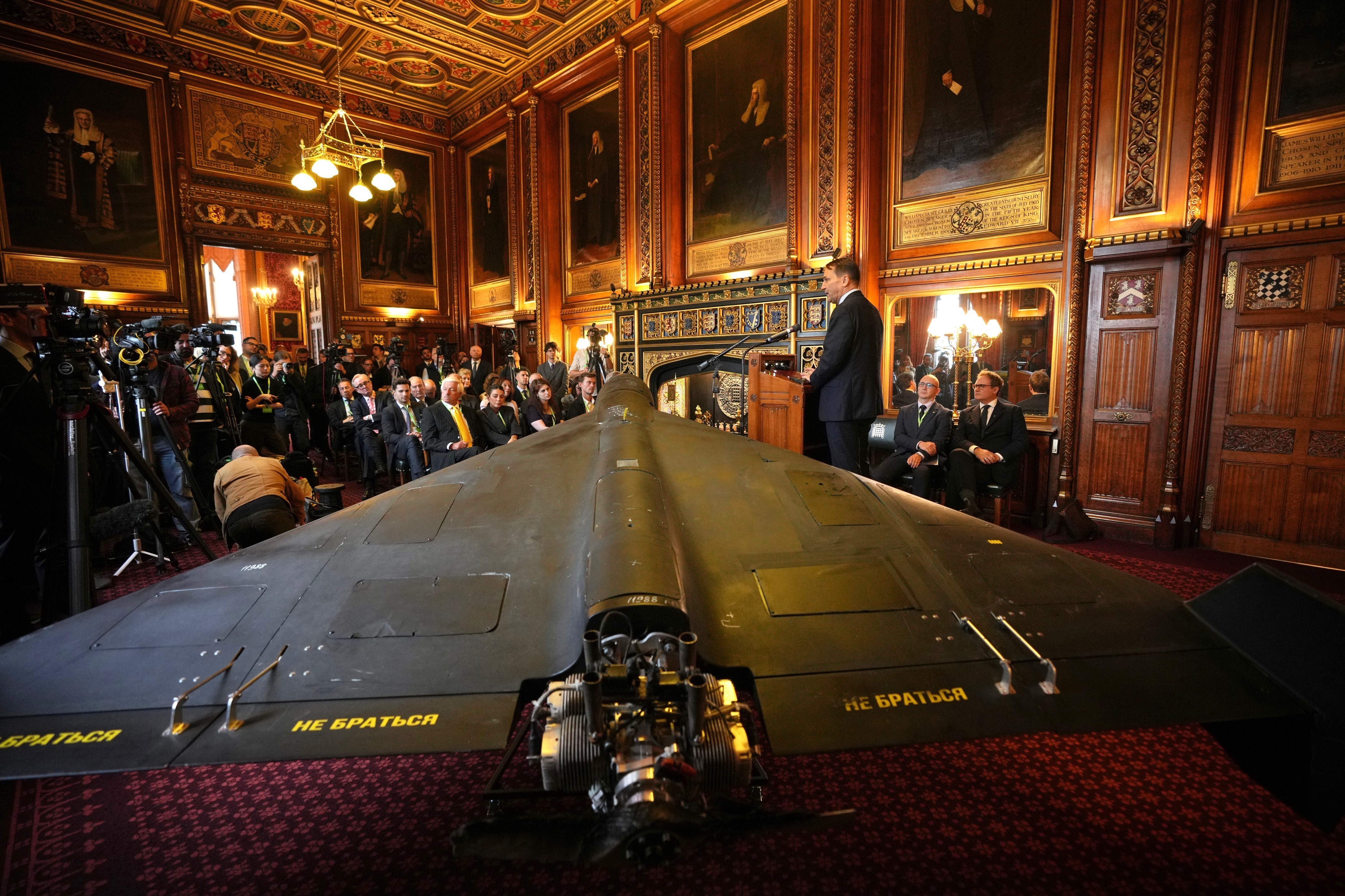 Polish Foreign Minister Radek Sikorski speaks at a press conference next to an Iranian Shahed-136 attack drone.