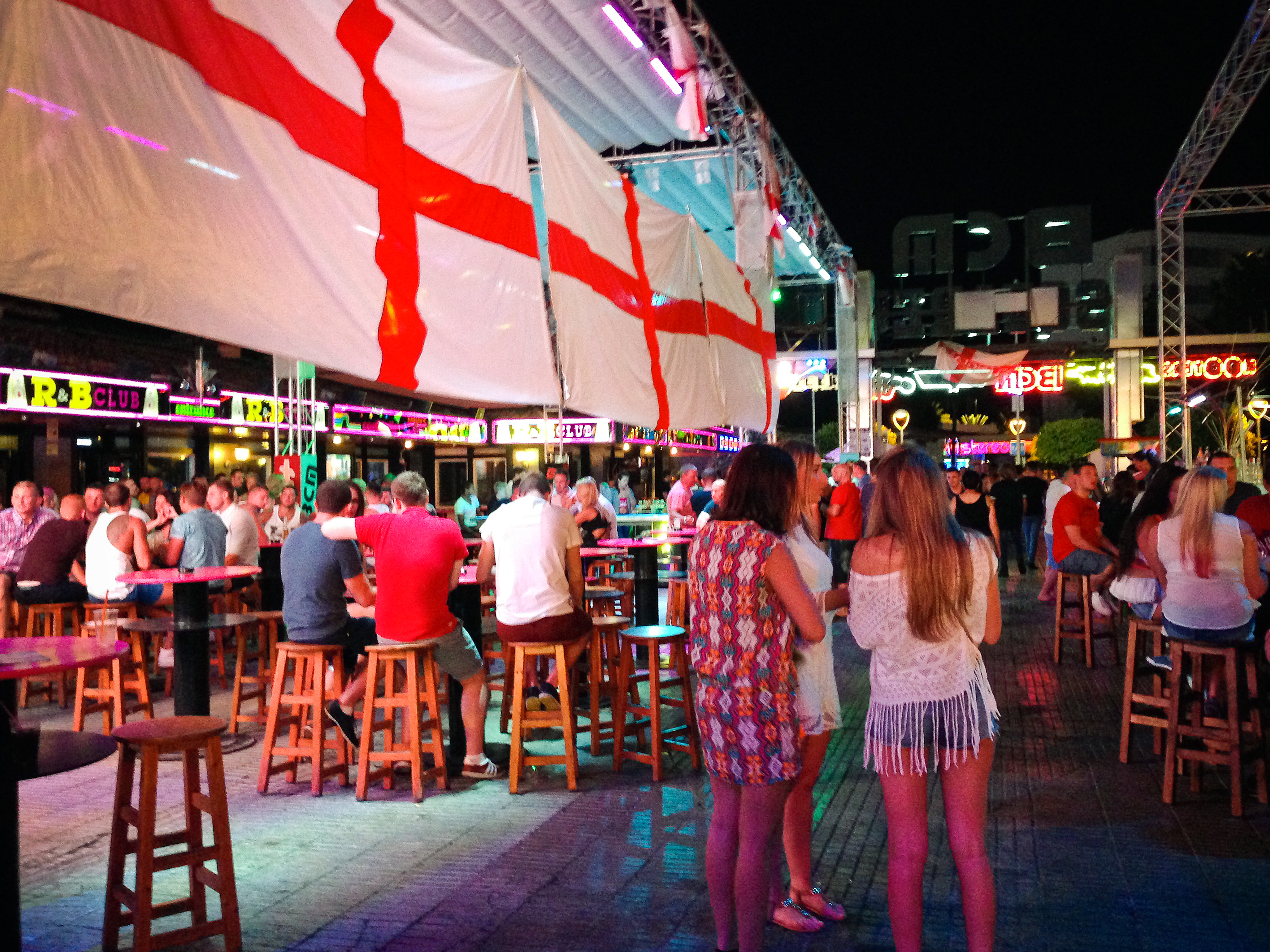 Tourists in a bar on Punta Ballena Street, also known as "the strip", in Mallorca, Spain.