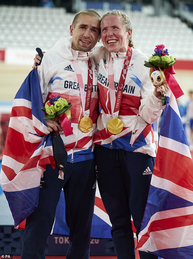 Neil and Lora Fachie with their respective Paralympic gold medals from Tokyo