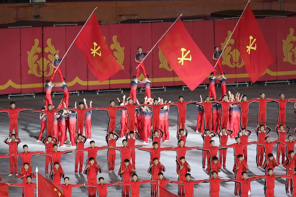 People wave the party flags during the ceremony marking the 80th anniversary of the founding of the ruling Workers’ Party at the May Day Stadium in Pyongyang, North Korea, Thursday, 9 October 2025 (AP)