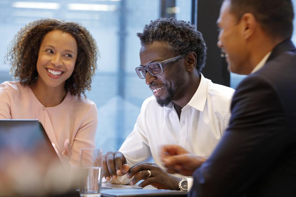 Business people interacting and laughing during a meeting