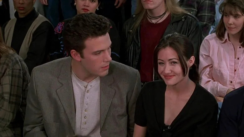 Rene sitting next to Shannon in the audience of a game show in Mallrats