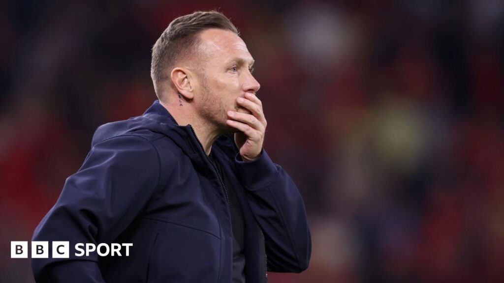 Wales boss Craig Bellamy looks reflective with hand over mouth