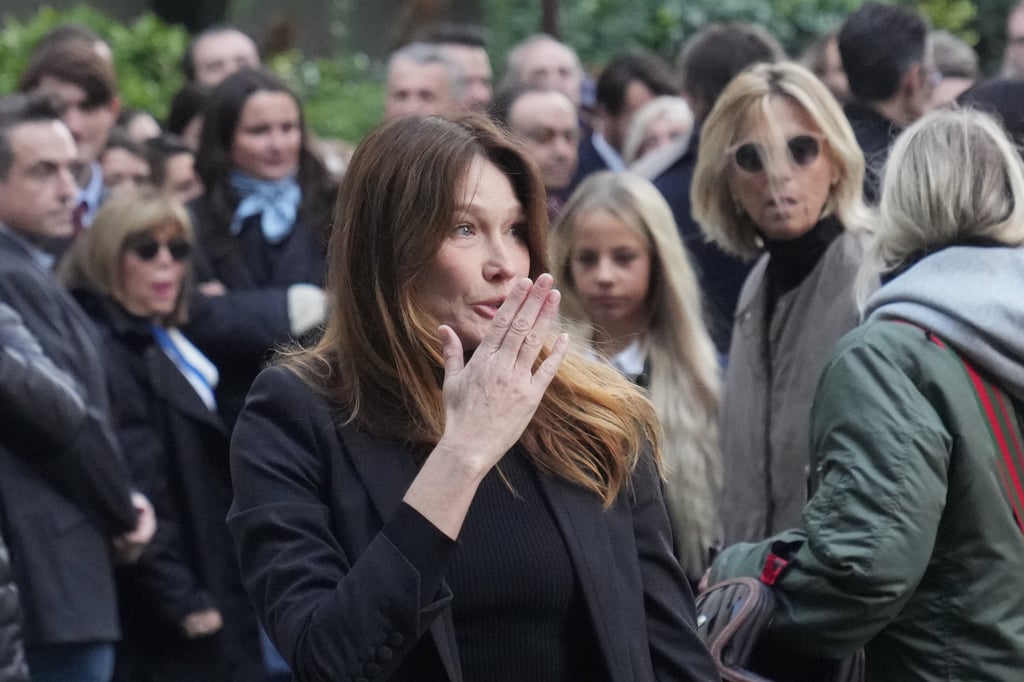 Carla Bruni blows a kiss as her husband heads to prison. Photo: AP