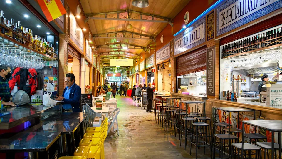 Seville, Spain - November 5 2023: Small cafes, bars and restaurants inside the covered Mercado de Triana, or Triana Market, in the Triana district of the Andalusian city of Seville, Spain.