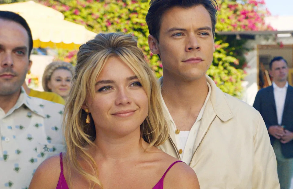 Florence Pugh and Harry Styles standing with a group of people in "Don't Worry Darling"