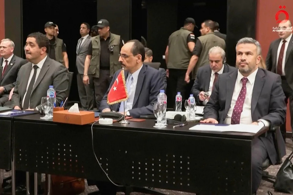 Director of the National Intelligence Organization of Turkey İbrahim Kalın, center, sits at a desk as he attends a meeting.