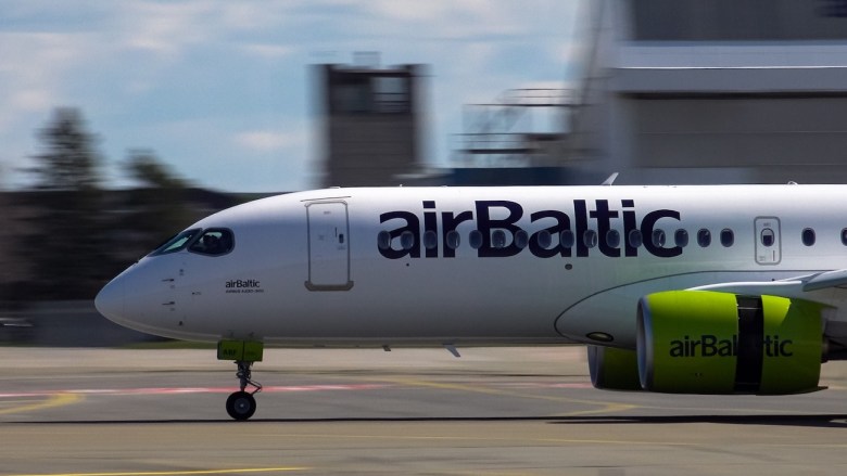 04.05.2022 Riga, Latvia. An airBaltic Airbus A220-300 taxiing at Riga International Airport, showing its sleek design and airline branding. Editorial credit: SCELERATOR / Shutterstock.com]